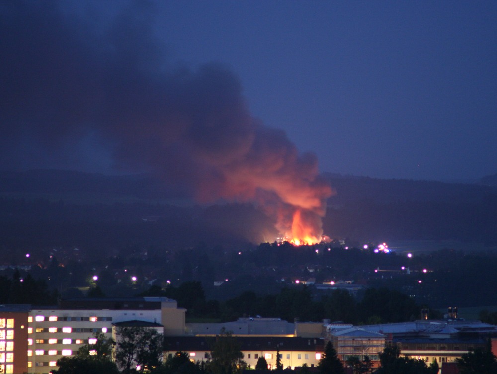 Building on fire in the next town, generating the obscuring smoke