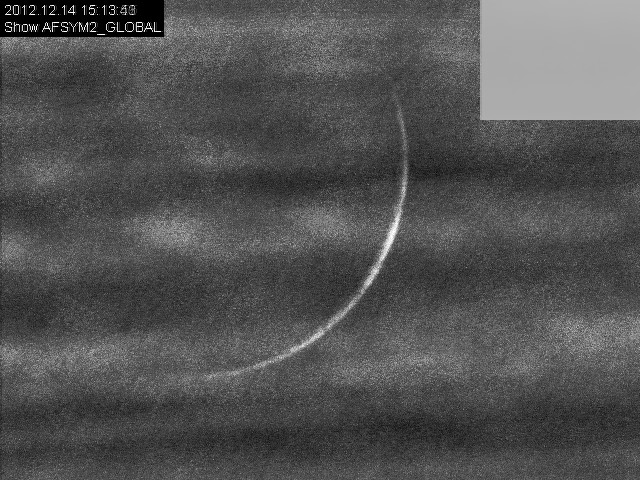 Crescent through clouds in daytime