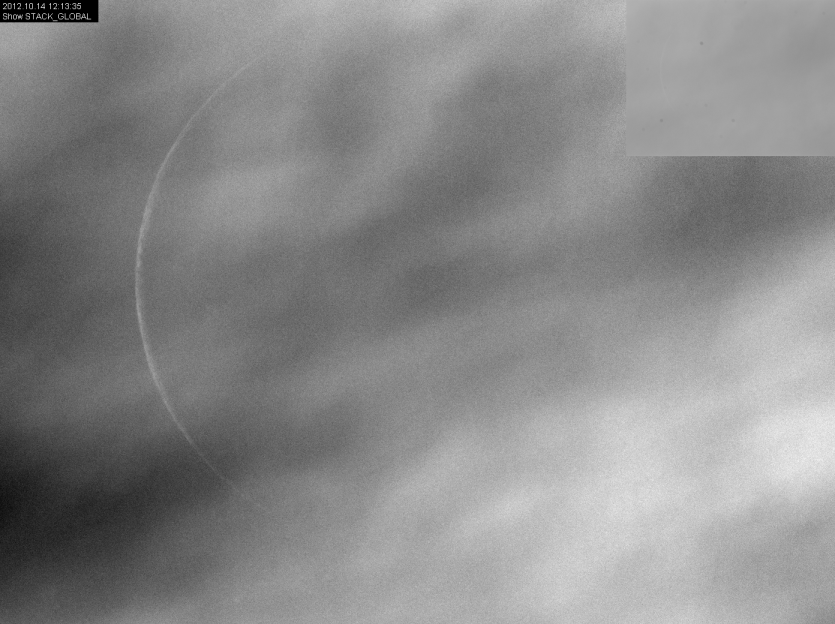 Crescent through clouds in daytime