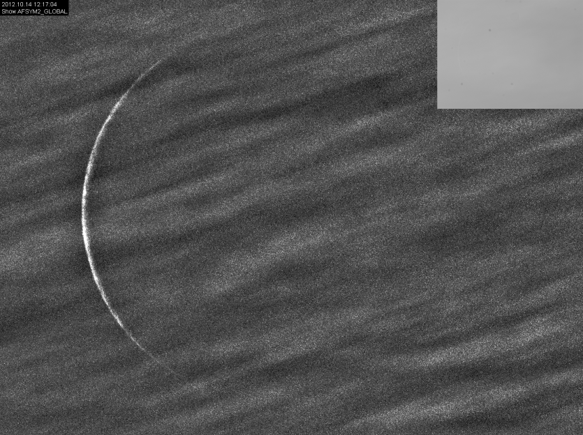 Crescent through clouds in daytime